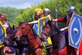 Four horse riders. Green trees foliage background.