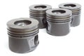 Four identical pistons on white background. spare internal combustion engine Royalty Free Stock Photo