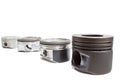 Four identical pistons on white background. spare internal combustion engine Royalty Free Stock Photo