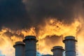 Four industrial chimneys spewing smoke in the sky Royalty Free Stock Photo