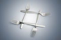 Four interlaced silver forks on blue gradiant Royalty Free Stock Photo