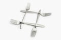 Four interlaced silver forks on white Royalty Free Stock Photo