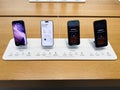 Four iPhones 17 on a retail display in a modern store showcasing latest models and features Royalty Free Stock Photo