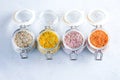 Four jars with different flavoured mixes of salt and spices. Himalayan and sea salt mixed with various peppers and herbs