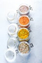 Four jars with different flavoured mixes of salt and spices. Himalayan and sea salt mixed with various peppers and herbs