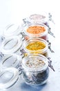 Four jars with different flavoured mixes of salt and spices. Himalayan and sea salt mixed with various peppers and herbs