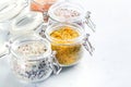 Four jars with different flavoured mixes of salt and spices. Himalayan and sea salt mixed with various peppers and herbs