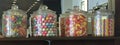 Four jars filled with various candies