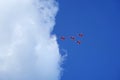 Four jet fighters, military planes flying into a white cloud against a blue sky, aerobatics Royalty Free Stock Photo