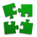 Four jigsaw puzzles with green grass, 3D illustration