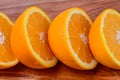 Sliced oranges in a row on a wood background