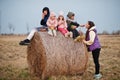 Four kids with mother having fun on haycock at field Royalty Free Stock Photo