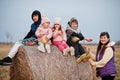 Four kids with mother having fun on haycock at field Royalty Free Stock Photo