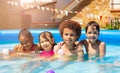 Four kids play in backyard swimming pool together Royalty Free Stock Photo