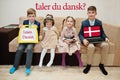 Four kids show inscription learn danish. Foreign language learning concept. Taler du dansk Royalty Free Stock Photo