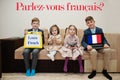 Four kids show inscription learn french. Foreign language learning concept. Parlez vous francais
