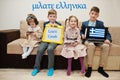 Four kids show inscription learn greek. Foreign language learning concept