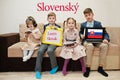 Four kids show inscription learn slovak. Foreign language learning concept. Slovensky
