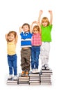 Four kids sitting on the books Royalty Free Stock Photo
