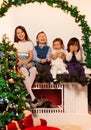 Four kids sitting on the fire place