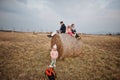 Four kids sitting on haycock at field Royalty Free Stock Photo