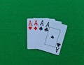 Four of kind cards of aces on green felt casino table background Royalty Free Stock Photo