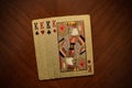 Four king playing cards on wooden background, four playing cards of the same suit, playing cards one on one from above the king of