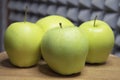 Four large apples, close-up. Fruit on a wooden surface