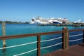 Four large cruise passenger ships observed from a wooden pier in Nassau harbour in the Bahamas.