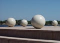 Four Large White Spheres On Outdoor Platform