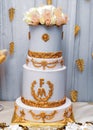 Four layer wedding cake decorated with flowers