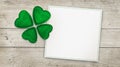Four leaf clover and greeting card on wood Royalty Free Stock Photo