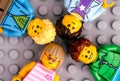 Four Lego children minifigures on gray baseplate background