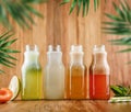 Four lemonade with strawberry, lemon, kiwi, apple, apricot, peach and mint in glass bottles on wooden background. Royalty Free Stock Photo