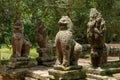 Four lion and snake statues in forest Royalty Free Stock Photo