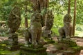 Four lion and snake statues in trees