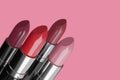 Four lipsticks isolated on pink background. 3d illustration