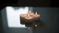 Four Lit Tea Light Candles with Reflections on Dark Surface Royalty Free Stock Photo