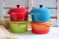 Four little colorful cooking pots and linen texture