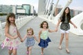 Four little girl group walking in the city