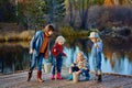 Four little girls catch fish on a wooden pontoon.Weekend at the lake. Fishing with friends. Royalty Free Stock Photo