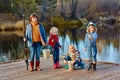 Four little girls catch fish on a wooden pontoon.Weekend at the lake. Fishing with friends. Royalty Free Stock Photo