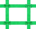 Four little green bow knots on four satin ribbon Royalty Free Stock Photo