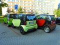 Four little Smart cars packed into a single parking place.