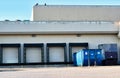 Four loading dock doors behind a commercial building. Royalty Free Stock Photo