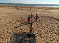 Four local children playing beach football