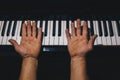 Four male hands on the piano. palms turned upside down on a keyboard in a music school. student learns to play. hands of a pianist Royalty Free Stock Photo