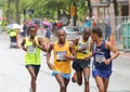 Four male runners in the lead