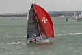 Four man crew and a racing yacht on The Solent during Cowes Week.