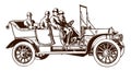 Four men with hats riding an open antique touring car